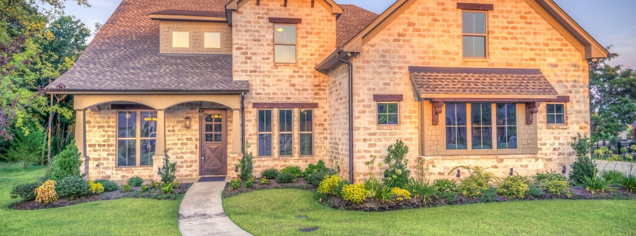 a stone house with green lawn